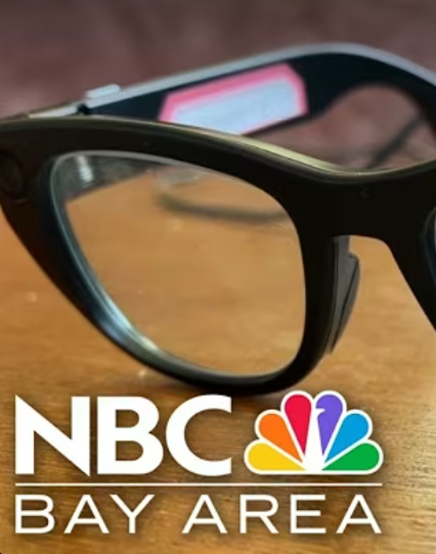 Black-framed glasses on a wooden surface with NBC Bay Area logo in the bottom of the picture.